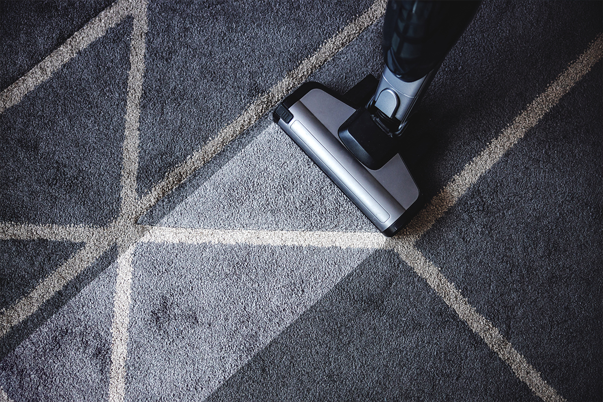 vacuuming a rug after cleaning