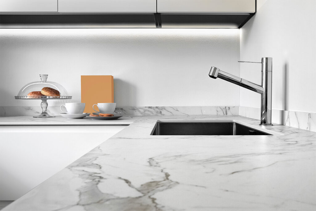 Rugmaker_Blog-Piece-SideImages_close up of a worktop of a modern kitchen in the foreground the steel sink and tap