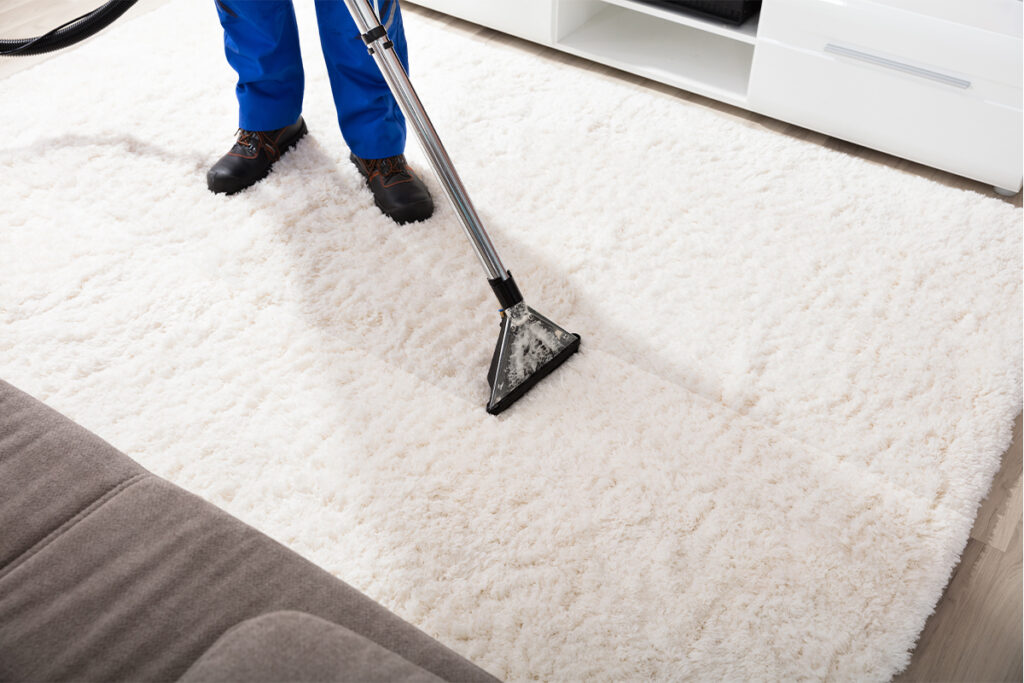 Rugmaker_Blog-Piece-SideImages_Close-up Of A Janitor Cleaning Carpet With Vacuum Cleaner At Home