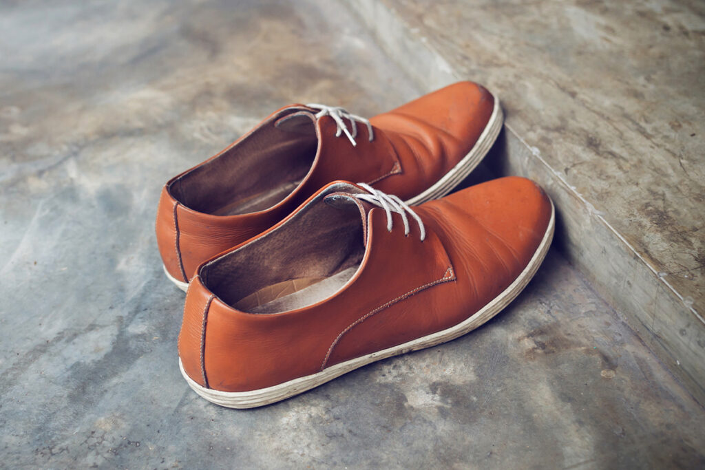 Rugmaker_Blog-Piece-SideImages_brown leather shoes fashion on cement floor