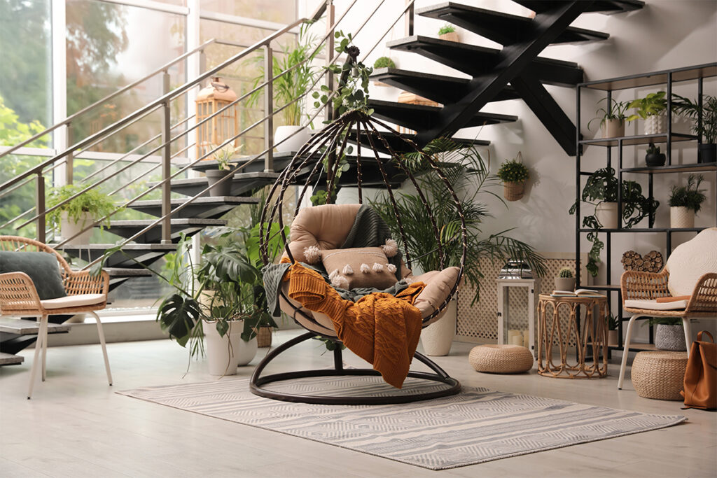 Rugmaker_Blog-Piece-SideImages_Indoor terrace interior with hanging chair and green plants