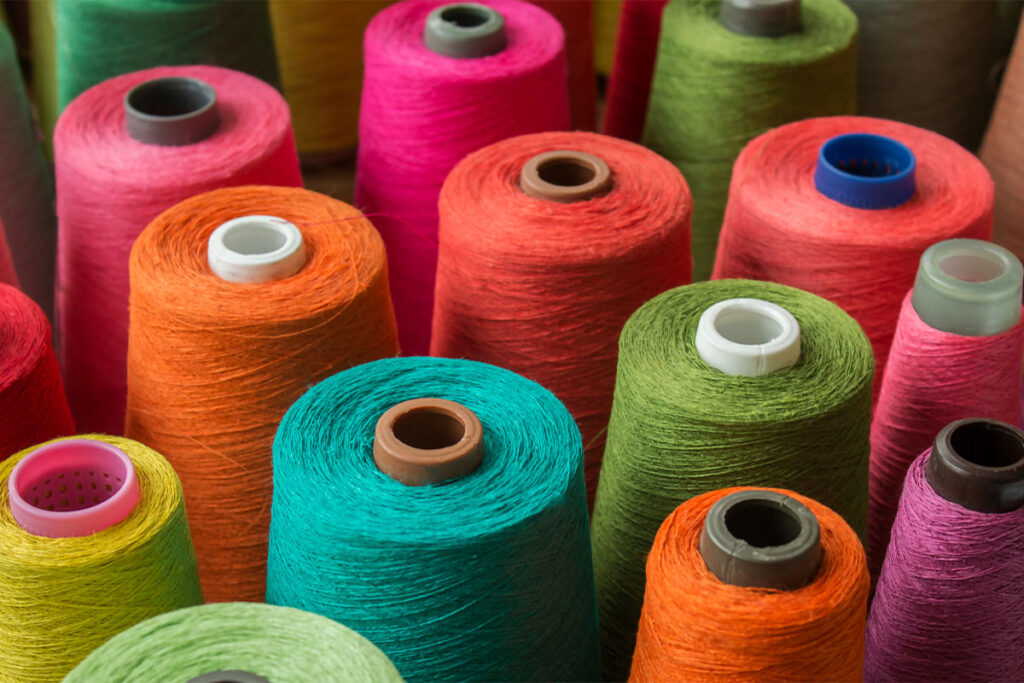 Rugmaker_Blog-Piece-SideImages_Colorful yarn on spool, yarn on tube, cotton, wool, linen thread