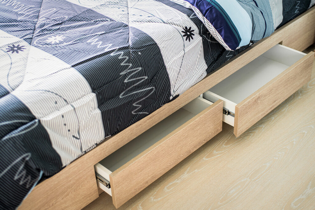 Rugmaker_Blog-Piece_Close up shot of opened drawer under modern bed in small bedroom