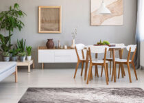 Rugmaker_Blog-Piece_Main Image_Panorama of a bright, spacious living and dining room interior with white, wooden furnitu