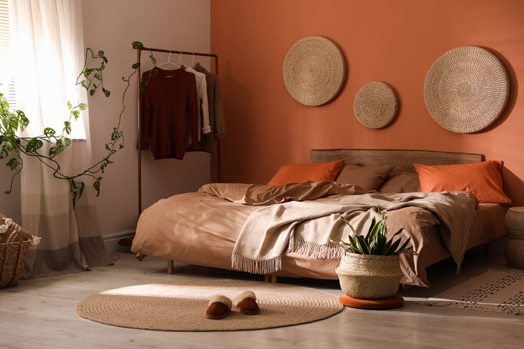 Rugmaker_Blog-Piece_Bed with orange and brown linens in stylish room interior