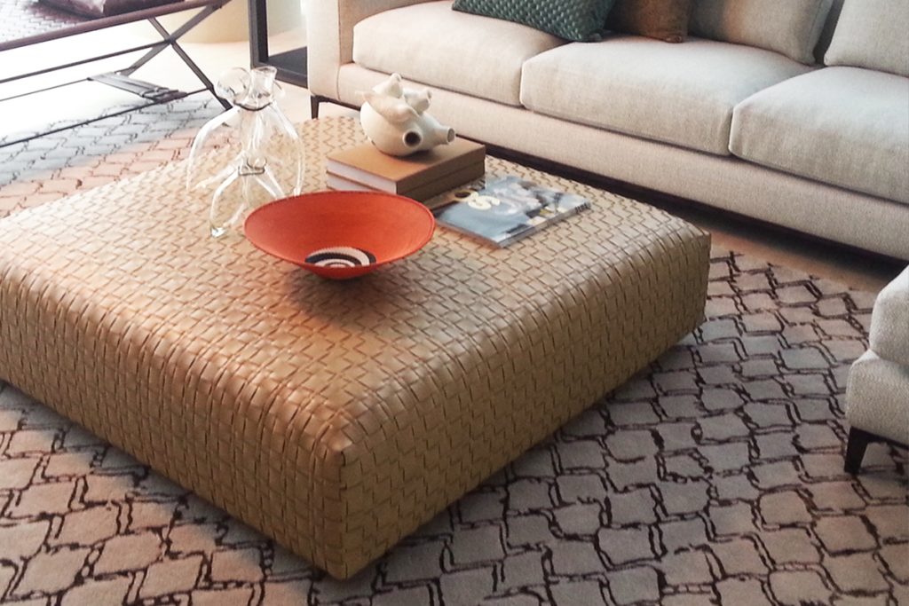Rugmaker_Blog-Piece_A modern living room with a large rug and big coffee table