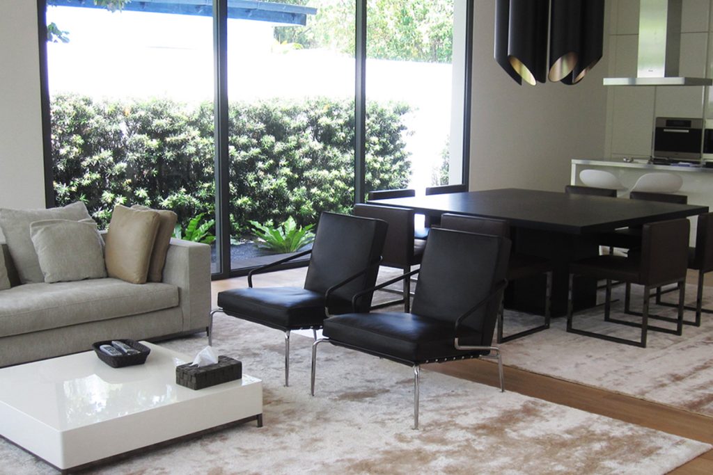 Rugmaker_Blog-Piece_Interior of modern living room and kitchen with cozy sofa and coffee table