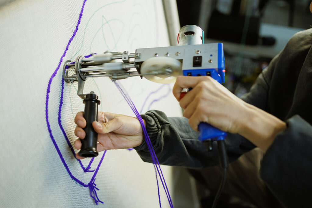 Rugmaker_Blog-Piece_Part of craftswoman making rug with carpet tufting gun