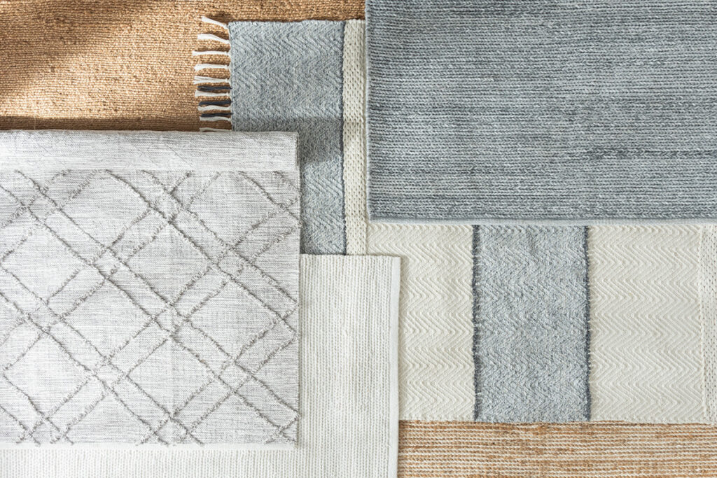 Rugmaker_Blog-Piece_Scandinavian inspired flatlay of artisanal handwoven rugs in ivory, light gray, blue and beige, show