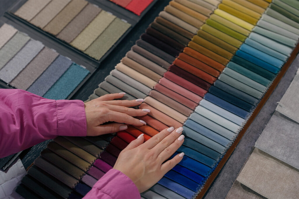 Rugmaker_Blog-Piece_fiber cloth choosing buying shopping colorful palette female fashion designer tailor arms choose dec